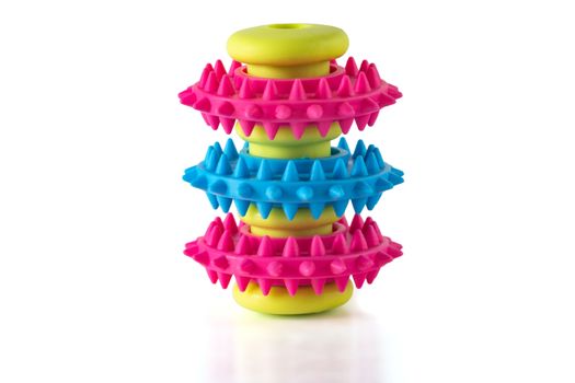 An unusual toy for a dog with three ribbed rings of blue and red colors on a light green sleeve. Toy isolated on a white background.