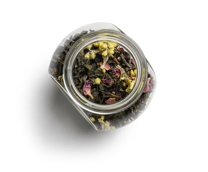 Green tea with aromatic additives. Top view on white background.