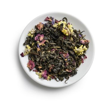 Green tea with aromatic additives. Top view on white background.