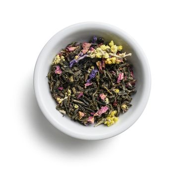 Green tea with aromatic additives. Top view on white background.