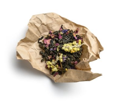 Green tea with aromatic additives. Top view on white background.