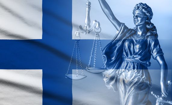 Flag of Finland with statue of Justice holding scales and sword in a full frame view with copy space