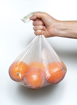 Some oranges in a plastic bag