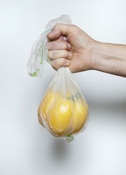 a yellow pepper in a plastic bag
