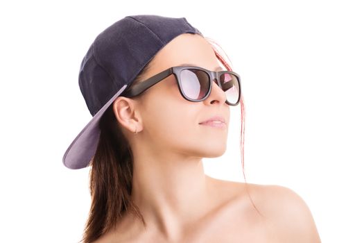 Profile shot of a beautiful stylish girl with backwards snapback cap and sunglasses, isolated on white background.