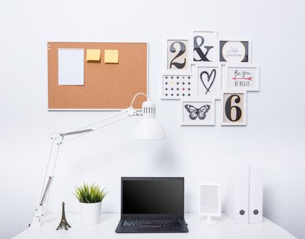 Modern home office notebook laptop computer workspace on white desk