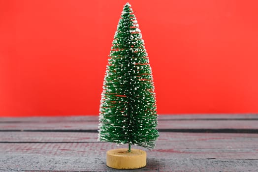 Christmas composition decorations, minimal green fir tree branches with snow on red background. Merry Christmas concept. Copy space for text
