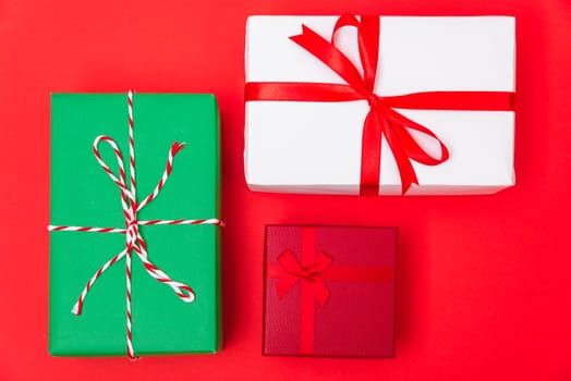Happy New Year and Christmas 2020 day, top view Xmas multi color gift boxes on red background with copy space for your text