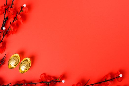 Chinese New Year, flat lay top view, gold bar and Chinese Flower on red background with copy space for your text