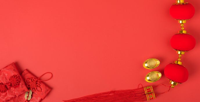 Chinese new year concept, flat lay top view, Happy Chinese new year with Red envelope and gold ingot (Character "FU" means fortune, blessing, wealth) on red background with copy space for your text