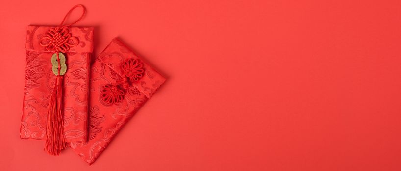 Chinese new year festival concept, flat lay top view, Happy Chinese new year with Red envelope (Character "FU" means fortune, blessing, wealth) on red background with copy space for your text