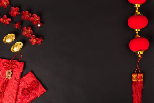 Chinese new year concept, flat lay top view, Happy Chinese new year with Red envelope and gold ingot (Character "FU" means fortune, blessing, wealth) on black background with copy space for your text