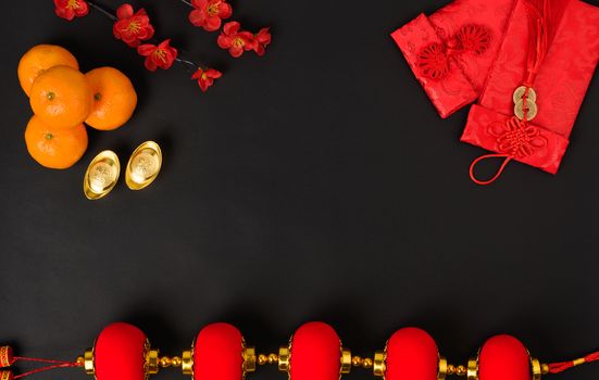 Chinese new year festival concept, flat lay top view, Happy Chinese new year with Red envelope and gold ingot (Character "FU" means fortune, blessing) on black background with copy space for text