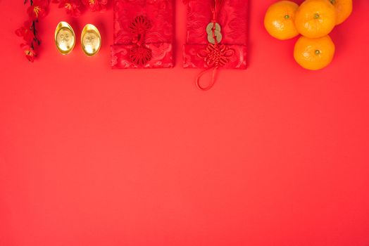 Chinese new year festival concept, flat lay top view, Happy Chinese new year with Red envelope and gold ingot (Character "FU" means fortune, blessing) on red background with copy space for text