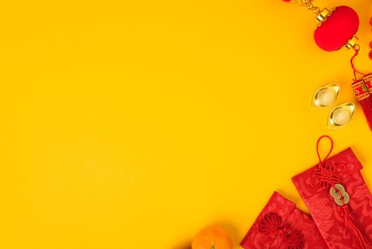 Chinese new year festival concept, flat lay top view, Happy Chinese new year with Red envelope and gold ingot (Character "FU" means fortune, blessing) on yellow background with copy space for text