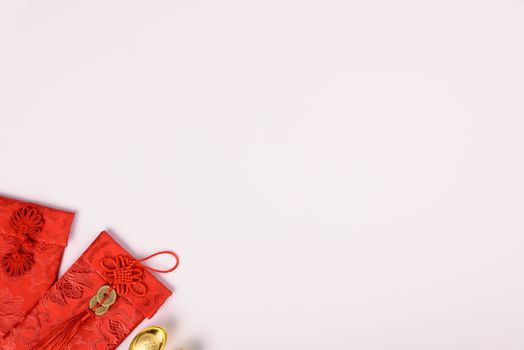 Chinese new year festival concept, flat lay top view, Happy Chinese new year with Red envelope and gold ingot (Character "FU" means fortune, blessing) on white background with copy space for text