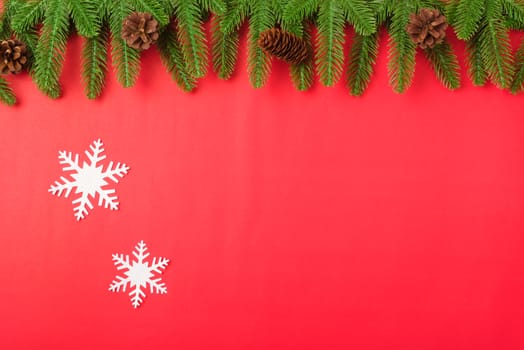 Happy new year or christmas day top view flat lay fir tree branches and decoration on red background with copy space for your text