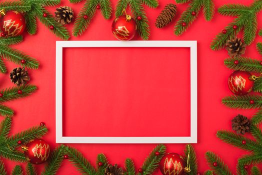 Happy new year or christmas day top view flat lay fir tree branches and decoration photo fram on red background with copy space for your text