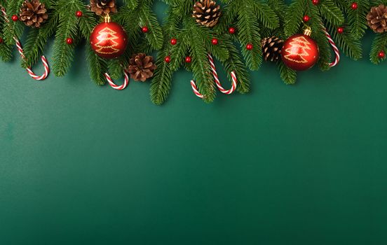 Happy new year, christmas day concept top view flat lay fir tree branches and decoration on Olive Green background with copy space for your text