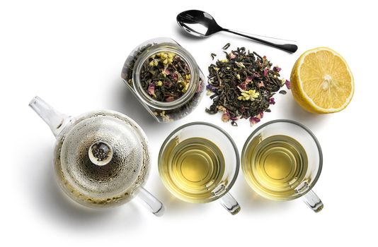 Green tea with natural aromatic additives and accessories. Top view on white background.