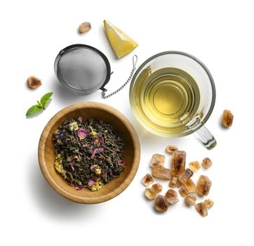 Green tea with natural aromatic additives and accessories. Top view on white background.