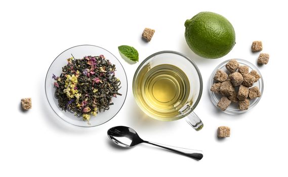 Green tea with natural aromatic additives and accessories. Top view on white background.