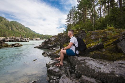 Woman resting at river in Altai Mountains territory