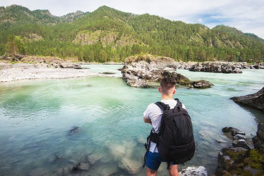 Man resting at river in Altai Mountains territory