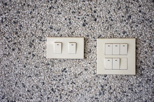 White plastic electrical switch On the marble wall