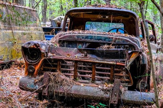Old Rusted Out Car in a Junkyard