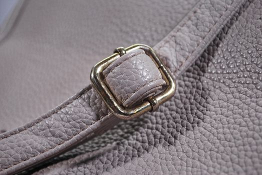 The adjusting strap for the space gray leather bag.