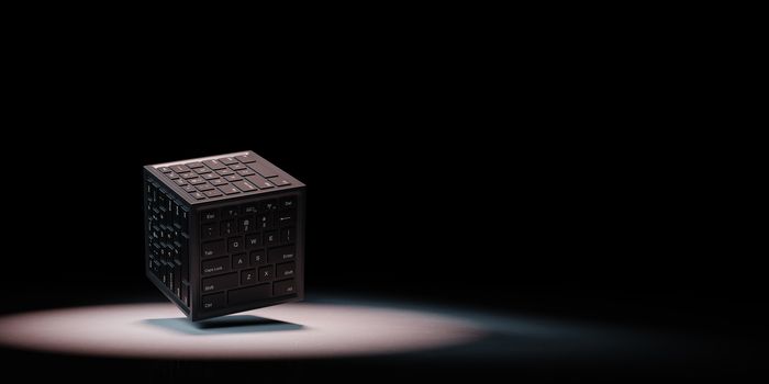 Cube Shape with Computer Keyboard on Faces Spotlighted on Black Background with Copy Space 3D Illustration