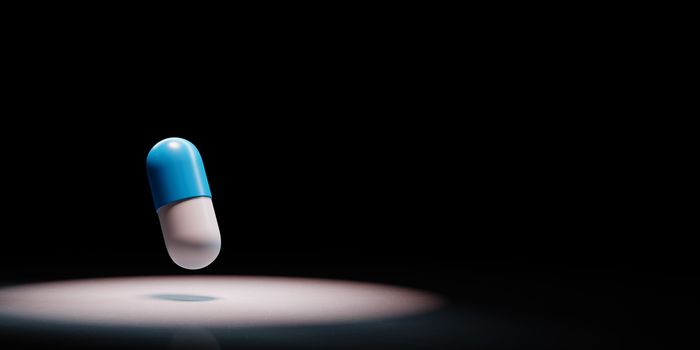 One Blue and White Pill Spotlighted on Black Background with Copy Space 3D Illustration