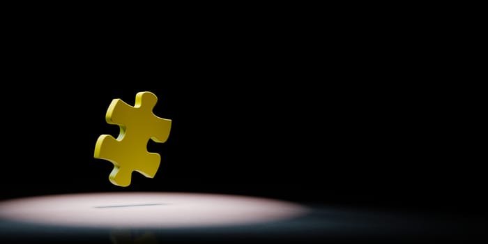 Yellow Puzzle Piece Spotlighted on Black Background with Copy Space 3D Illustration