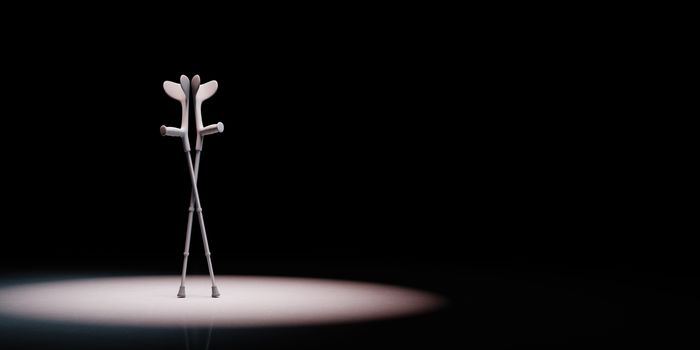 Crutches Spotlighted on Black Background with Copy Space 3D Illustration