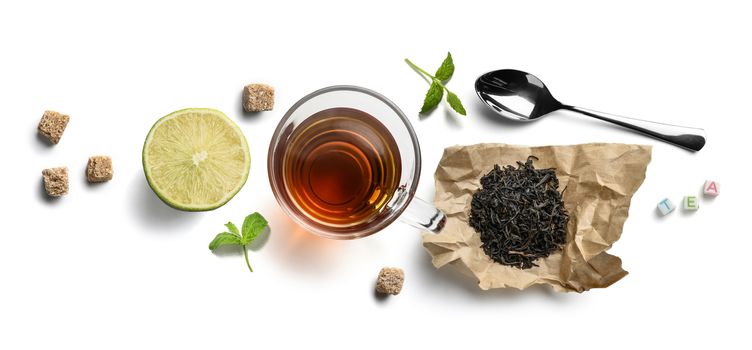 Black tea and accessories top view on white background.