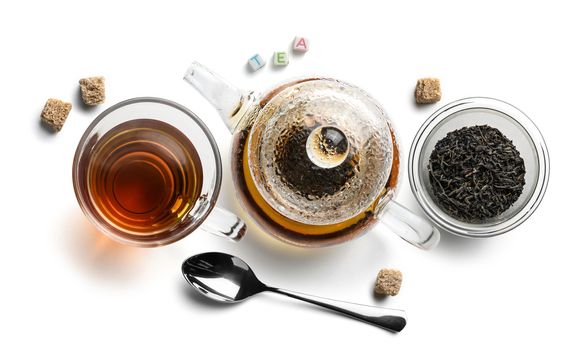 Black tea and accessories top view on white background.