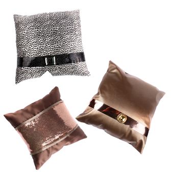 A set of luxurious pillows with beautiful designs, on white studio background.