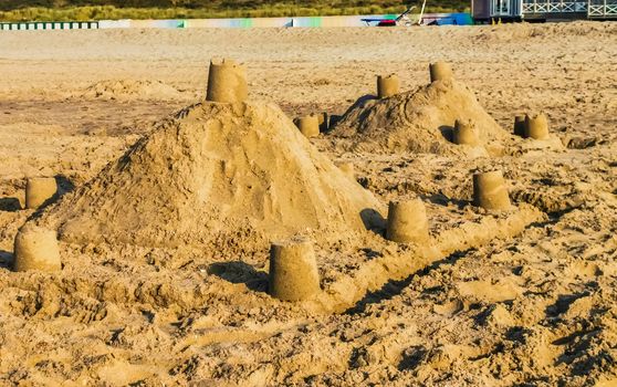 kids and adult creativity, Sand castles on the beach, summer season background