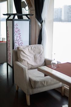 table near the window of a large light window, restaurant cozy interior texture of a wooden wall