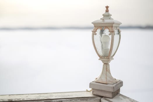 decorative white wooden lantern on Board ship, winter frosty white background