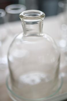 vintage clear glass bottles are close together, light background