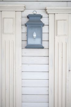 old lamp lantern iron black hanging on white painted old wall, home outdoor decoration