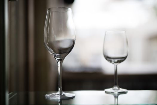 two transparent glass stand on the table without a drink, transparent background, bokeh