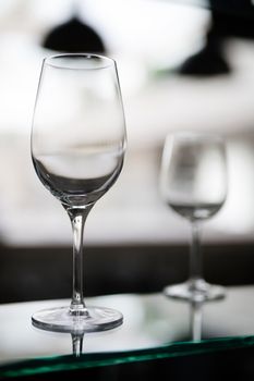 two transparent glass stand on the table without a drink, transparent background, bokeh