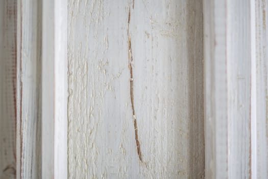 old white cracked paint on the boards, vintage background, crack in the window
