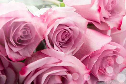 Flower arrangement - a bouquet of pink roses on table close up.