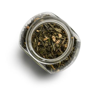 Green tea with aromatic additives. Top view on white background.