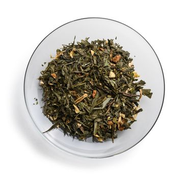 Green tea with aromatic additives. Top view on white background.