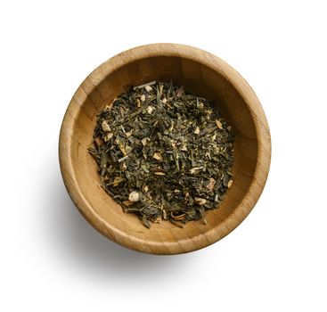 Green tea with aromatic additives. Top view on white background.